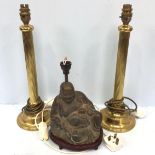 A pair of brass reeded column table lamps, with two-prong plugs, together with a cast metal Buddha