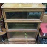 A three-section oak stacking bookcase by Globe-Wernicke, each section with typical glazed up and