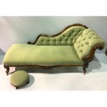 A Victorian mahogany chaise lounge, with green fabric upholstery and deep button back, raised on