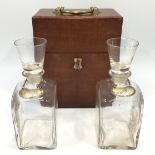 A 19th century mahogany two division decanter box, the lockable, hinged lid with brass handle,