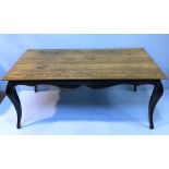 A rectangular oak and black painted dining table, with shaped frieze and raised on cabriole