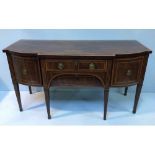 A George III mahogany and cross-banded break-front sideboard, with central drawers and recessed