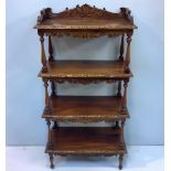 A 20th century walnut whatnot with four shelves with foliate carved sides and raised 3/4 gallery,
