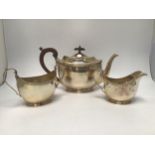 A three-piece silver tea service by Adie Brothers Ltd, comprising teapot, sugar bowl and milk jug,