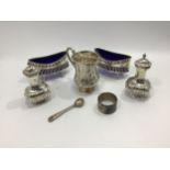 A small collection of assorted silver items comprising a pair of open salts with blue glass liners