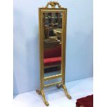 A full length gold gilt framed cheval mirror with decorative floral design to the top (af) on