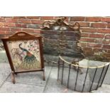A Rococo revival style brass spark guard, a brass metal spark guard and a oak-framed fire screen