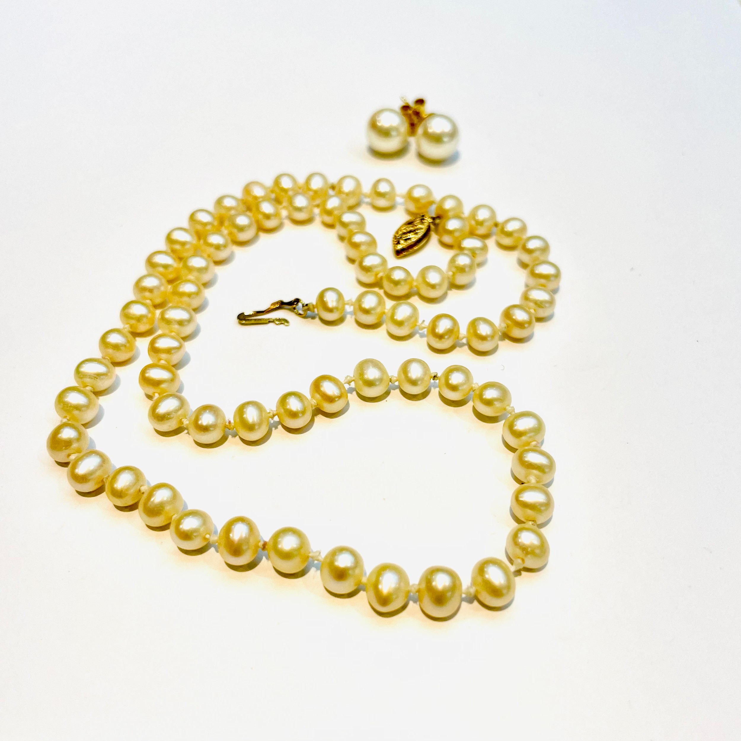 A string of cultured pearls, knotted, 5mm in diameter, with 9ct gold clasp, together with a pair