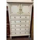 An early 20th century French style chest of drawers with a small cabinet to the top finished in a