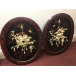 A pair of late 19th / early 20th century Japanese carved ivory floral displays mounted on oval