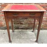 A Liberty style oak desk, the sliding top with red vinyl scribe and studded detail, opening to