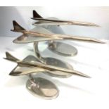 Two large aluminium Concorde desk ornaments raised on oval bases, 42 x 17 x 18cm, together with a