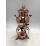 A 20th century copper and brass twin-handled samovar with glass lid, raised on pierced cabriole
