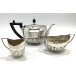 A Victorian silver three-piece tea set comprising teapot with half reeded body, ebonised handle