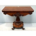 A William IV mahogany folding card table of rectangular form with circular green baize, scroll