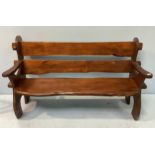 A rustic stained pine bench with raised back and armrests, raised on curved ends approx. 150cm