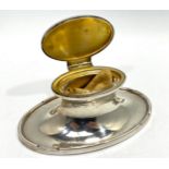 An Asprey's of London loaded silver inkwell of oval waisted form, with clear glass liner and