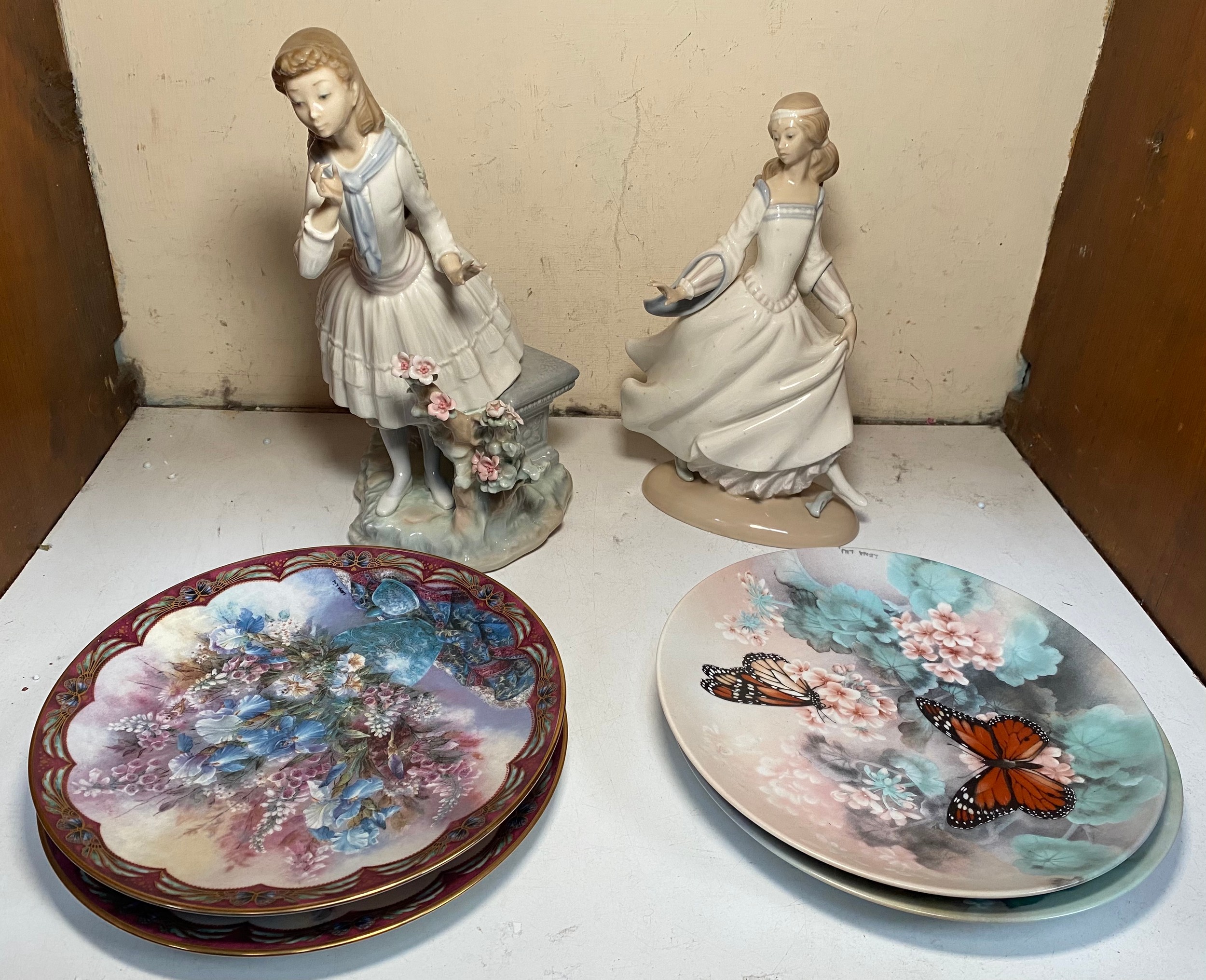 Two various large Lladro porcelain figures including a lady with straw hat and blue ribbon around