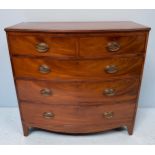 A Victorian mahogany bow front chest of two short, over three long, graduated drawers, with