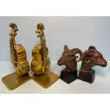 A pair of cast and patinated bronzed bookends modelled as rams heads raised on tapered plinth