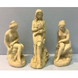 A pair of heavy composite garden statues of nude seated females, together with another statue of a