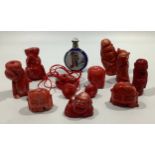 A quantity of Chinese red stone or marble snuff bottles modelled as monkeys, together with another