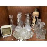A collection of six assorted glass decanters and a glass claret jug, together with a small glass