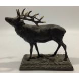 A bronze sculpture of a stag raised on naturalistic base, 15 x 17cm long