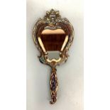 A 19th century champlevé enamel hand mirror, with shaped bevelled mirror and suspension loop to
