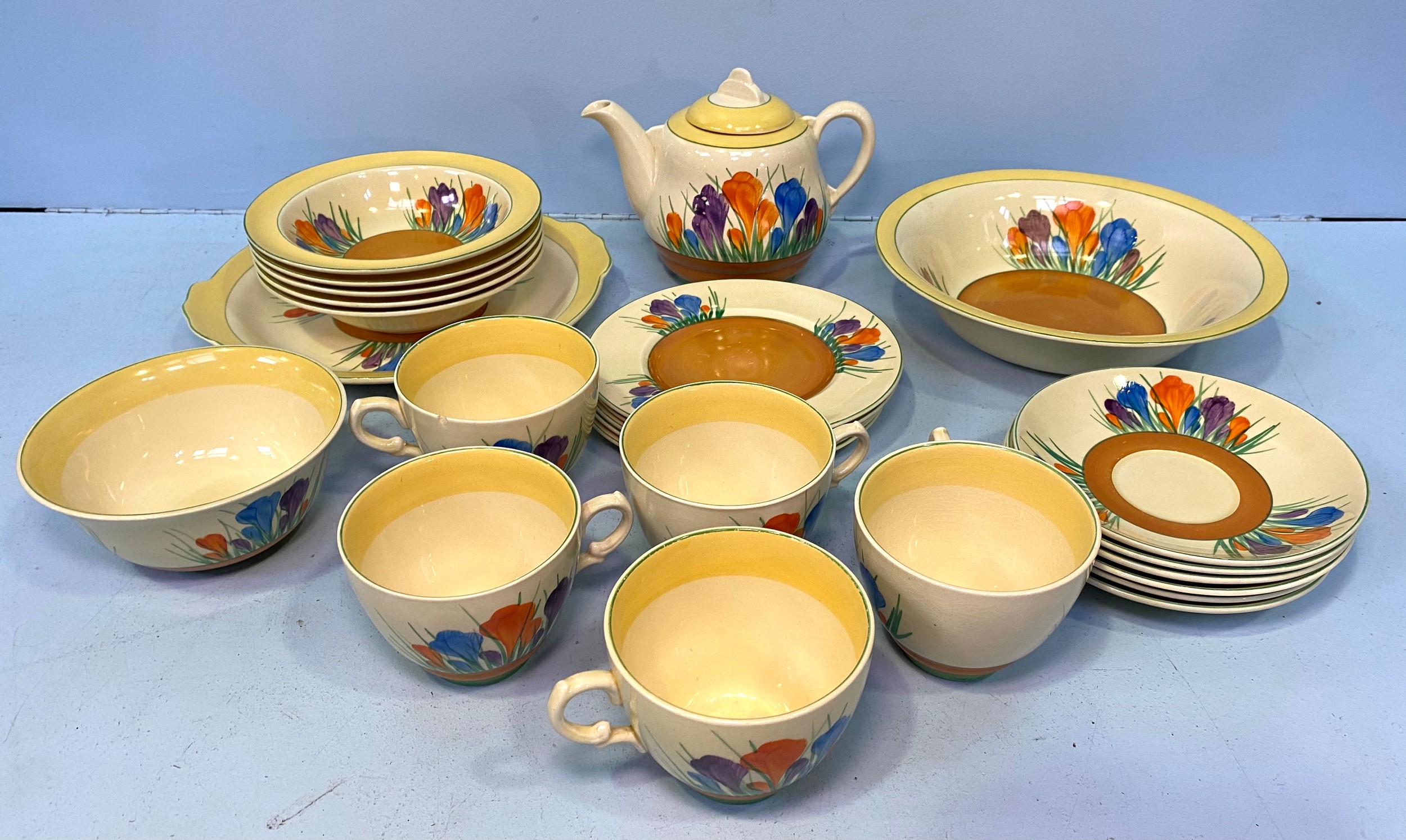 A 25-piece Royal Staffordshire Crocus by Clarice Cliff tea set comprising cups, saucers, a teapot,