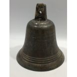 A 19th century bronze bell and clapper marked '19' to top of bell, three band decorative belt,