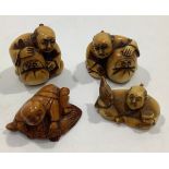 Three various early 20th century ivory carved Netsuke figures and a boxwood example, including a