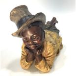 A late 19th/early 20th century Austrian painted terracotta figure of a recumbent African American