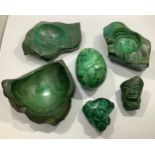 A large polished malachite egg together with three malachite stands and another malachite