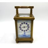 A Swiss brass cased carriage clock with blue and white porcelain panelled sides and dial panel,