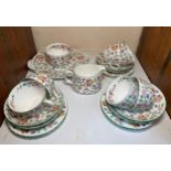 A Minton Haddon Hall part tea service comprising six-each cups, saucers and cake plates, cake