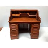 A 20th century roll top desk by Angus of London, the top opening to reveal drawer (one missing)