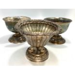 A .800 grade silver Bon-Bon dish, with floral carved rim, to a vertically reeded body, raised on