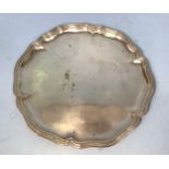 An .800 grade German silver salver, with makers mark for Hermann Behrnd, with shaped rim and