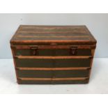 A large vintage wooden and leather bound canvas steamer trunk, the cover opening to reveal padded