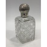 A silver-topped cut glass perfume / scent bottle of rectangular form, with glass stopper, silver