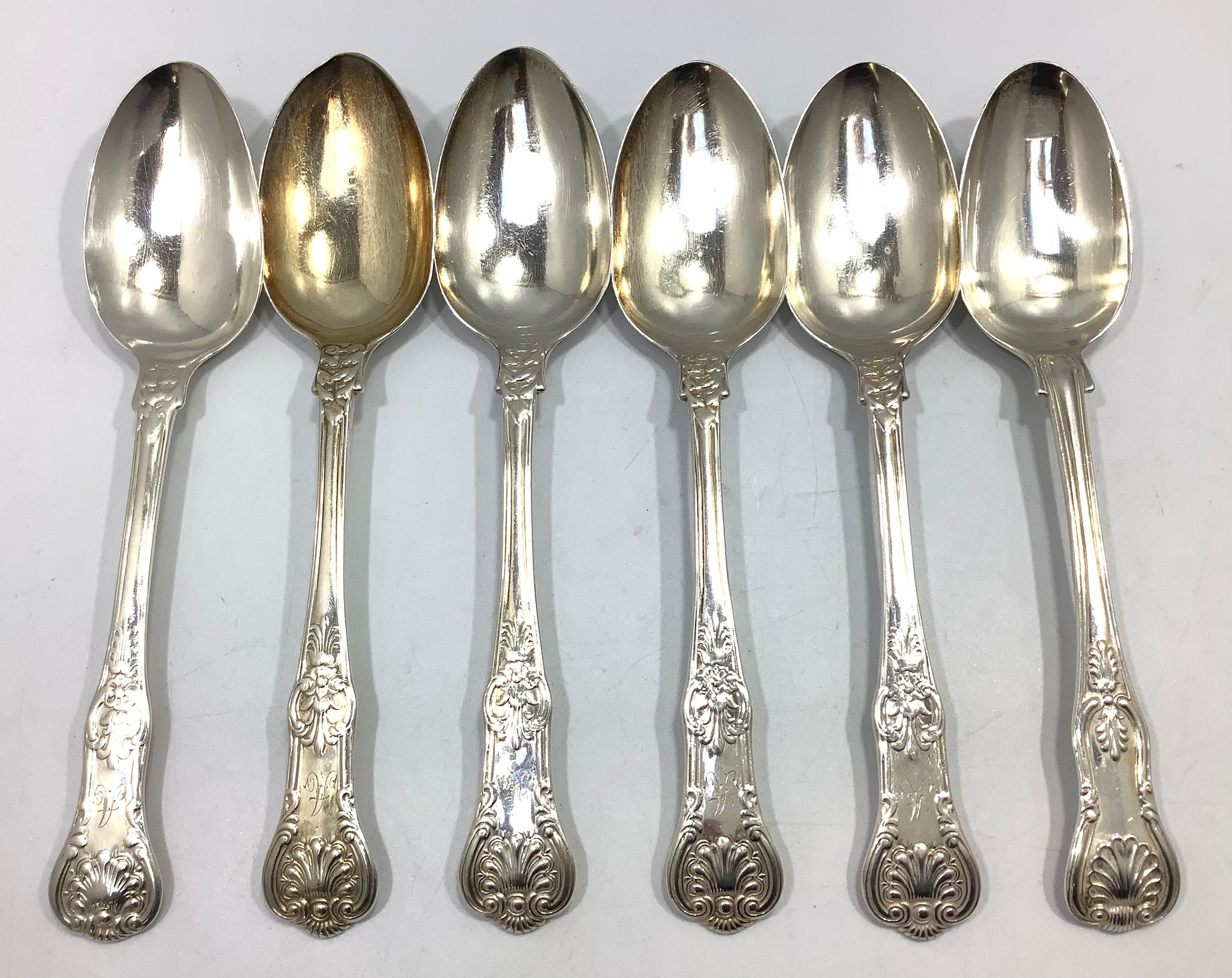Four Georgian silver Queens pattern serving spoons, London 1837, together with two Georgian silver