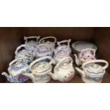 A collection of eleven ceramic kettles including Wedgwood 'Regency' and Coalport 'Gold Trellis and