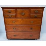 An Edwardian walnut chest of drawers, with central hat drawer flanked by four short drawers, above