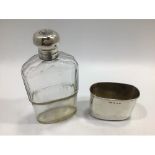 A silver mounted and faceted glass hip flask, with twist and flip top engraved with monogram, silver