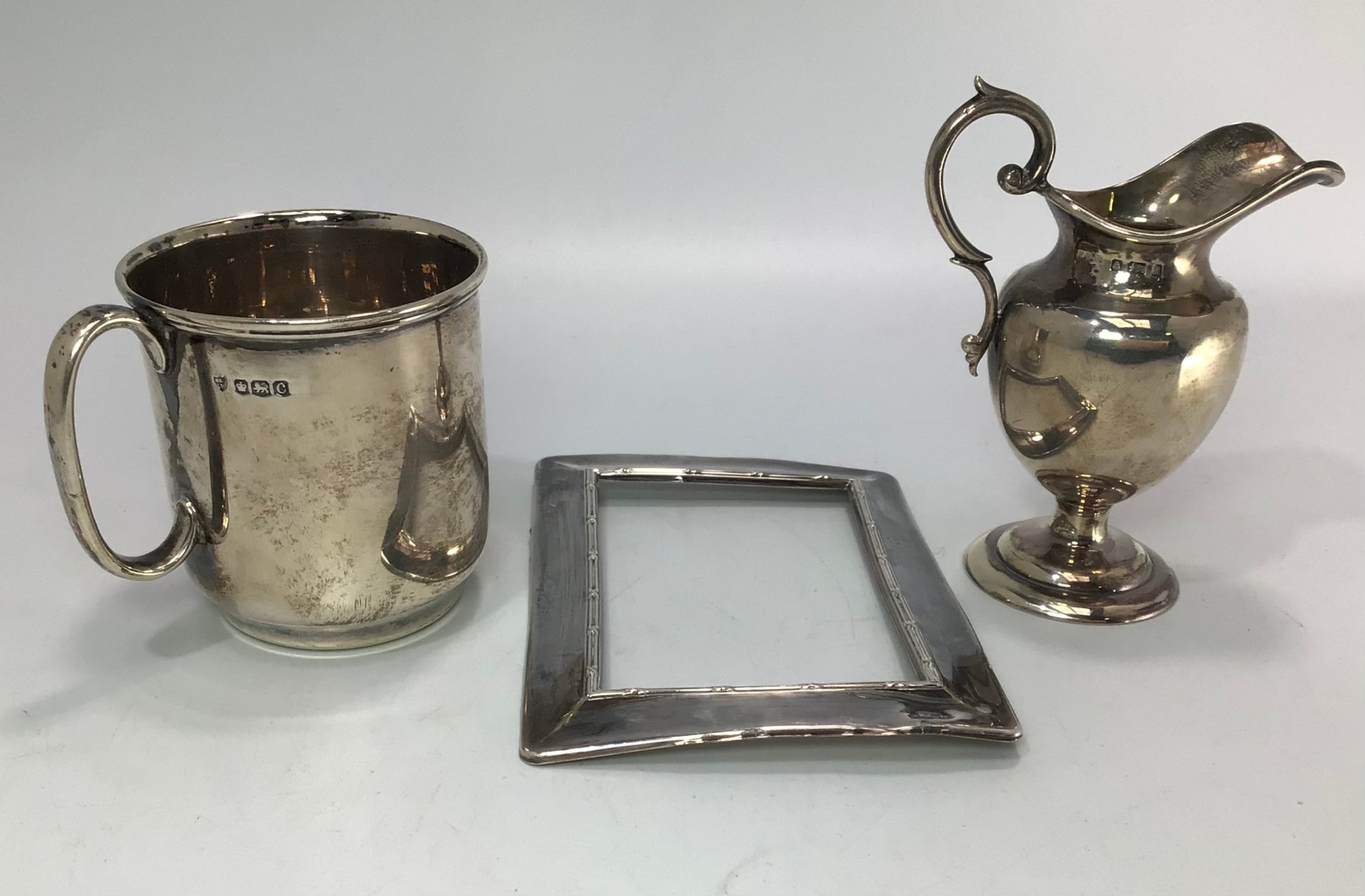 Three assorted silver items comprising a christening cup by Maxfield & Sons Ltd. Hallmarked