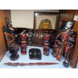 A quantity of African wooden carved figures and an Egyptian papyrus