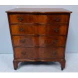 A reproduction mahogany veneered serpentine chest of drawers, with pierced brass handles, and