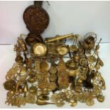 A large quantity of brass wares including a large canon with 30cm barrel, bellows, horse and trap,
