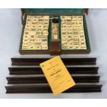 A bone-faced and bamboo Mah - Jong set by 'Jackpot', with tiles, dice, racks and rules etc. housed